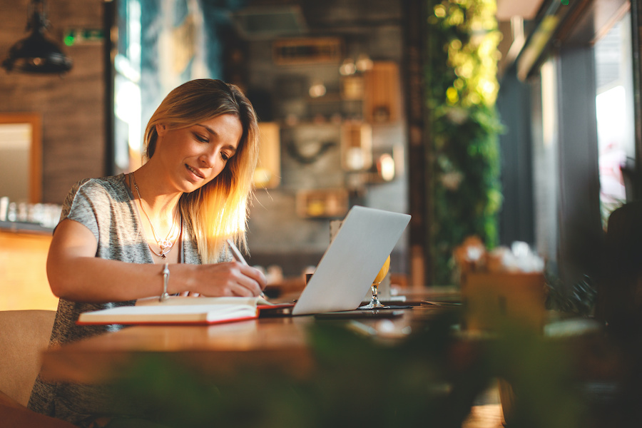 blonde woman writing <a href=