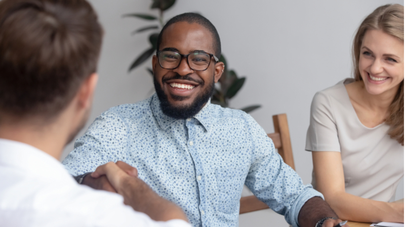 african american student shaking hand with another colleague