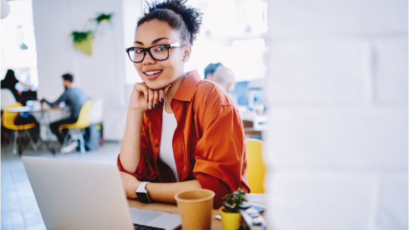 woman with eyeglasses working on her laptop in a shared office