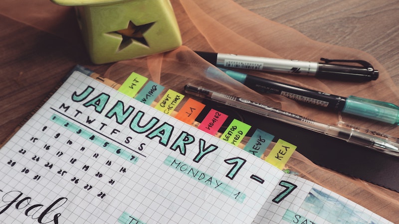 custom drawn calendar in a notebook with color notes