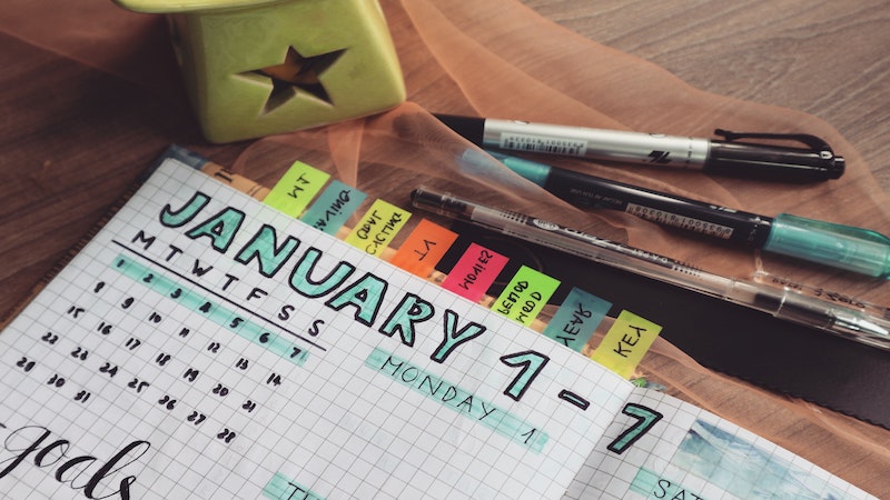 custom calendar in a notebook with colorful notes