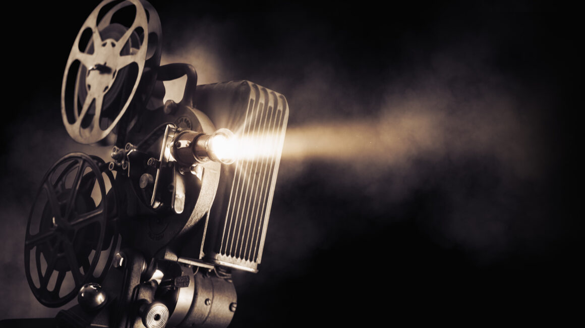A movie projector surrounded by smoke