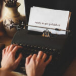 person typing at a typewriter, the text says I am ready to publish
