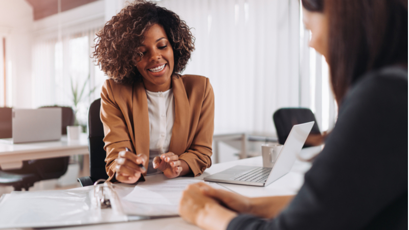 african americanwoman with curly hair consulting a client