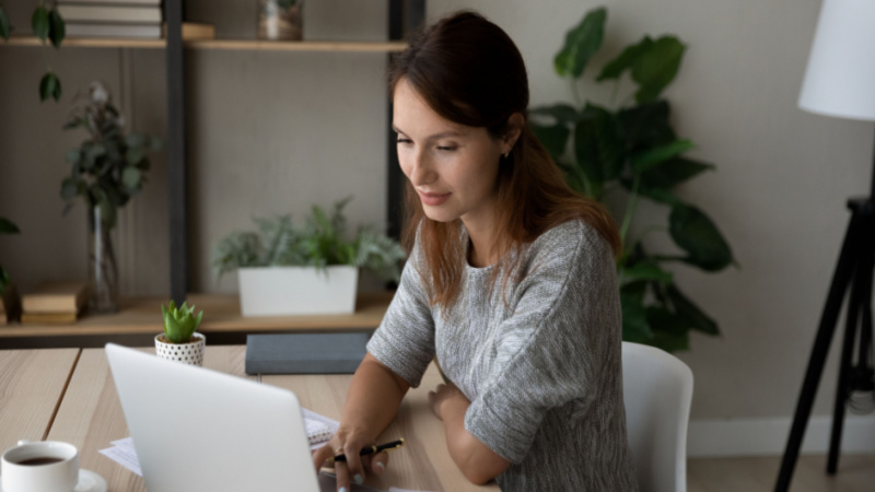 woman studying on her laptop at her home office