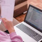 grad student preparing a dissertation paper on her laptop